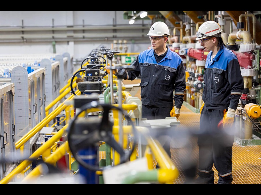 Employees working inside a factory hall.