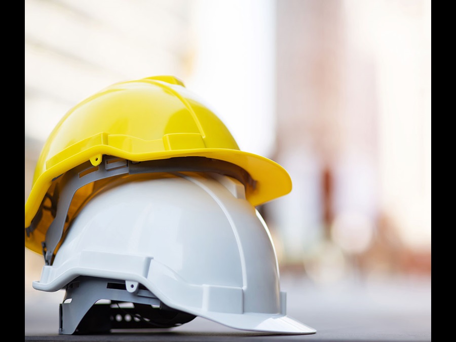 Two construction hard hats on a table