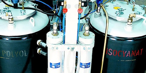 View of two gas tank cylinders connected to different pipes and valves.