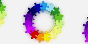 Colorful puzzle pieces that form several circles.