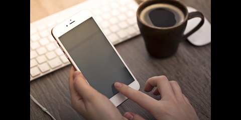Close-up of two hands holding a smartphone.