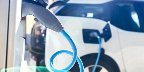 Electric car is charging at charging station