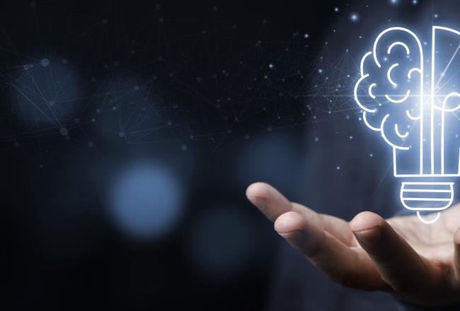 Hand with a light bulb that is partly shaped like a brain